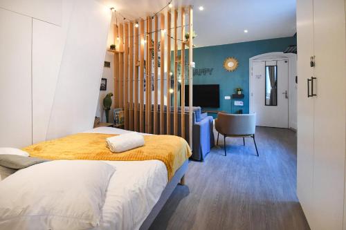 a bedroom with a bed and a desk at Au Bretzel Doré - Centre Historique in Colmar