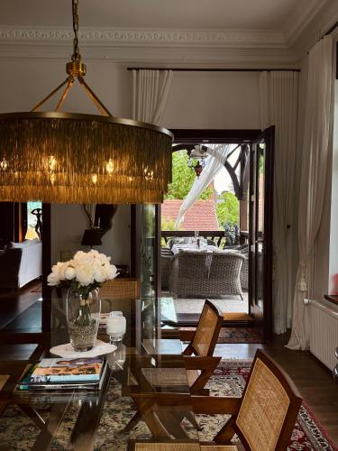 a living room with a glass table and chairs at Villa Pomona in Bled