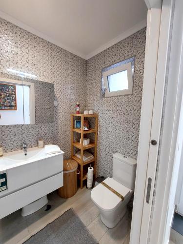 a bathroom with a toilet and a sink at Casa do Frade in Abrantes