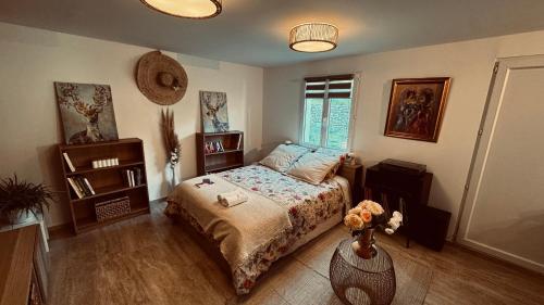 a bedroom with a bed and a window at suite romantique jacuzzi & piscine privée en pleine forêt in Saint-Zacharie