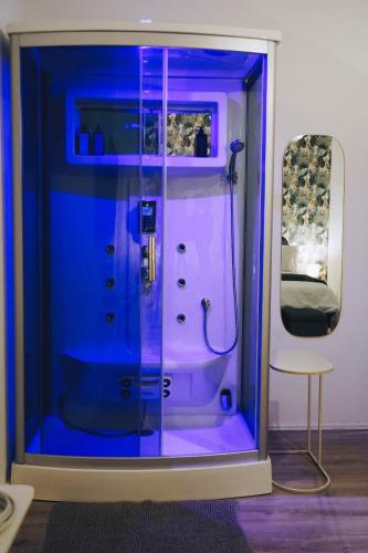 a blue aquarium with a shower in a room at Portico Provenzali in Cento