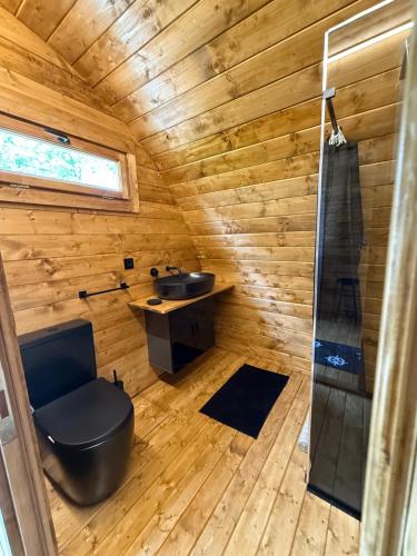 a wooden bathroom with a toilet and a sink at Floating Dream in Fiano