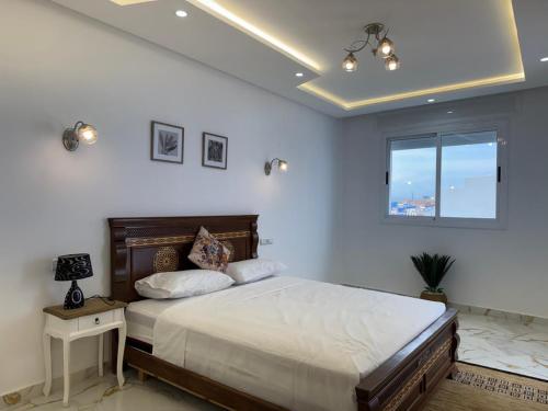 a bedroom with a large bed and a window at Dalal house in Chefchaouen