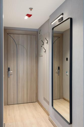 a mirror in a dressing room with two doors at Marina Club in Batumi