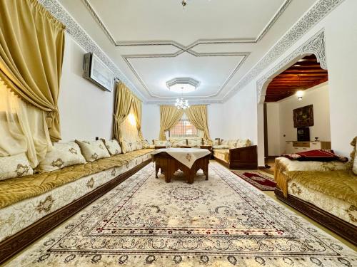a living room with a couch and a table at Marrakech ferme lodge in Marrakesh