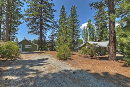 a house in the woods with a yard with trees at Applewood Cabins & Guest Cabin Near the Village in Big Bear Lake