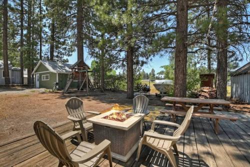 a patio with a table and chairs and a fire pit at Applewood Cabins & Guest Cabin Near the Village in Big Bear Lake