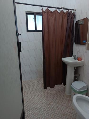 a bathroom with a shower curtain and a sink at Finca la Esperanza in Guadalupe