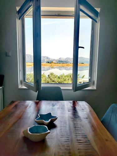 a dining room table with a view of a window at Holiday home Ilijaš with home gym in Mihalj