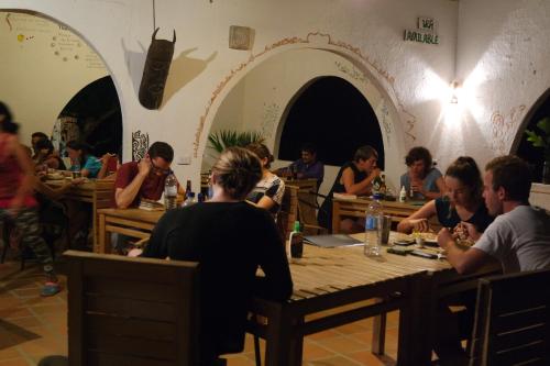 a group of people sitting at tables in a restaurant at Finca Carpe Diem Ecolodge in Minca