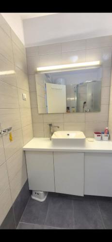 a bathroom with a sink and a mirror at Take it slow in Postira