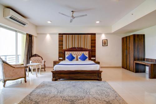 a bedroom with a bed with blue pillows on it at The Zean Luxury in Jāmb