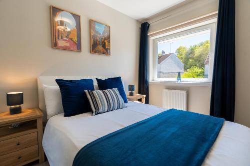 a bedroom with a large bed and a window at The Willows in Hurlet