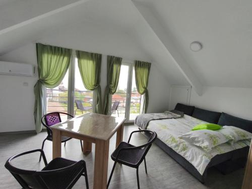 a bedroom with a bed and a table and chairs at Villa Hristina in Elshani