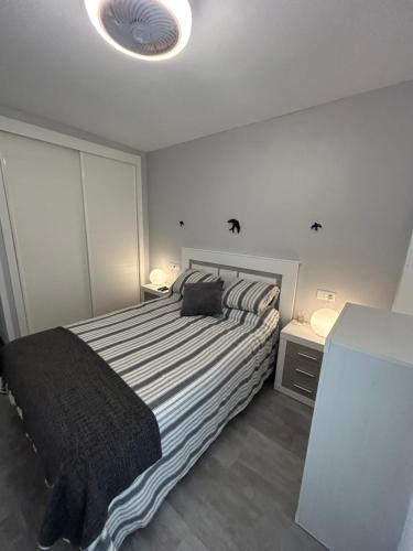 a bedroom with a large bed with a black blanket at Apartment zona Naturista in Vera
