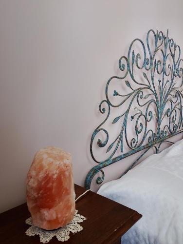 a donut sitting on a table next to a bed at I Quattro Venti in Pralormo