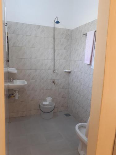 a bathroom with a toilet and a sink at Résidence Stellahouado in Avlékété