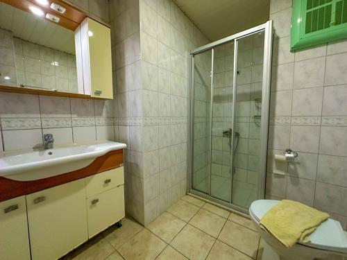 a bathroom with a sink and a shower at Adora Pansiyon in Side