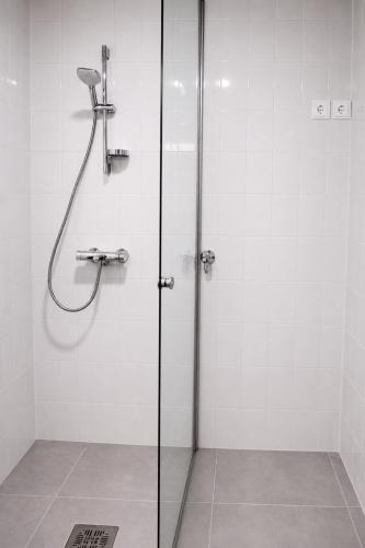 a shower with a glass door in a bathroom at City Heaven in Turku