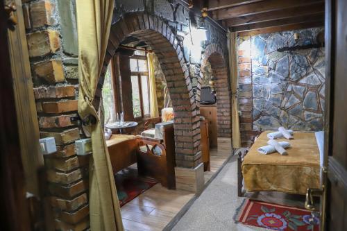 a room with a brick wall and a table with teddy bears at Hotel Nasho Vruho in Berat