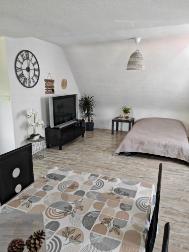 a living room with a bed and a table at Gîte du logelbach in Wintzenheim