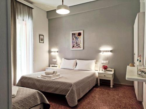 a hotel room with a bed and a window at Apartments Papadioti in Pefki