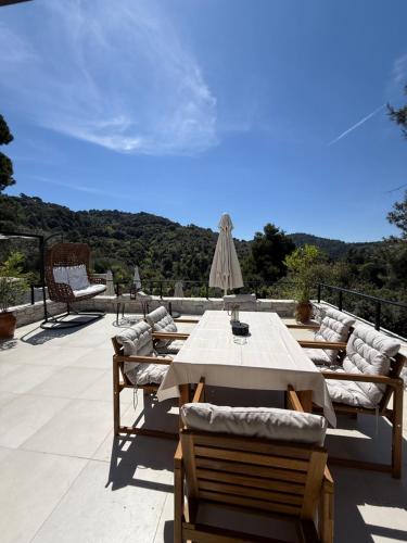 a table and chairs on a patio with a view at Damari Luxury 3 Bedroom Villas with Private Pool, Skiathos in Skiathos