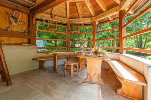 a dining room with a table and bench in a cabin at House Mavko Near Lake Cerknica - Happy Rentals in Grahovo