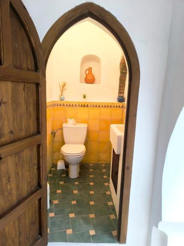 a bathroom with a toilet and a sink at Riad Louisa in Chefchaouen