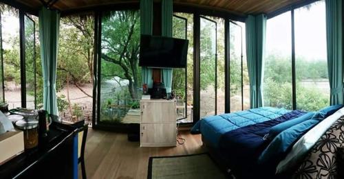 柏森的住宿－邦法特寧靜度假屋，一间设有蓝色床的卧室,位于带窗户的房间内