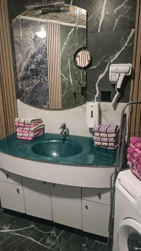 a bathroom with a sink and a mirror at LUX Apartman Sarajevo Centar in Sarajevo