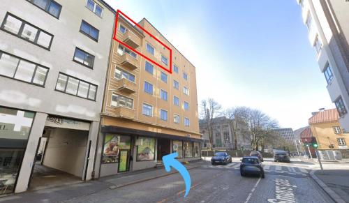 a building with a blue arrow on a city street at JS10 - 2BR Central Bergen Views in Bergen