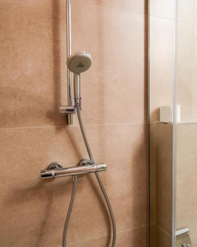 a shower with a shower head in a bathroom at Kulla e Sahatit - Boutique Hotel in Old Bazaar in Gjakove