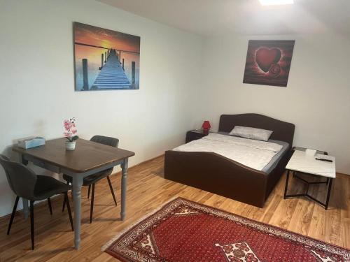 a small room with a bed and a table and a table and a tableablish at LUNA in Bad Säckingen