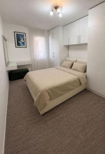 a bedroom with a large bed with white cabinets at Mivasto Sea View in Risan