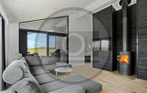 a living room with a couch and a fireplace at Awesome Home In Jerup With Sauna in Jerup