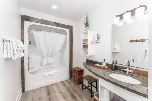 a bathroom with a shower and a sink at Spectacular Penthouse With Amazing Views, Indoor Pool and Hot tub in Canmore