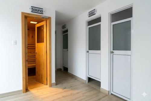 a hallway with two doors in a room at CarDiem Suites in Baños