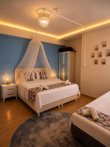a bedroom with two beds and a canopy bed at Grand Sur Butik Otel in Diyarbakır