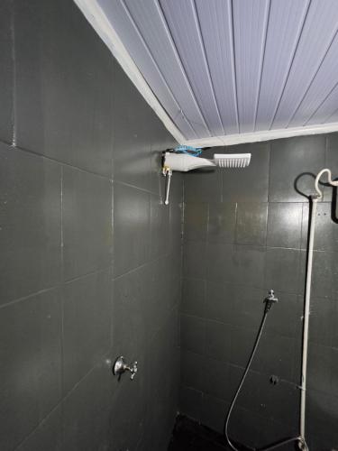 a bathroom with a shower with a blow dryer on the wall at Ypane Residencial in Ypane