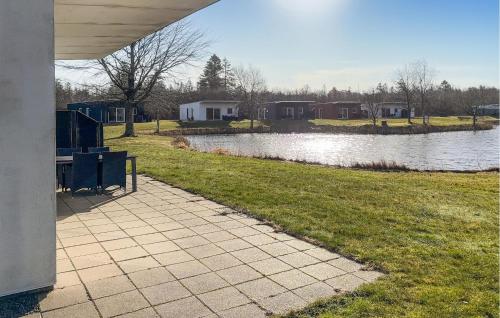 a walkway next to a body of water with houses at Stunning Home In Ringkøbing With Wifi in Ringkøbing