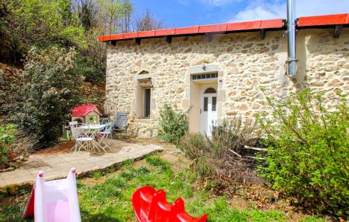 a stone cottage with a table and chairs in front of it at Mazet Du Gua in La Pervenche