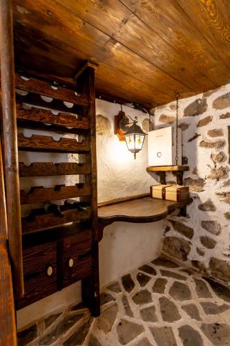 a small room with a wooden table and a lamp at Velev House in Melnik