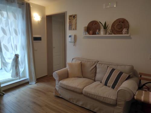 a living room with a couch and a window at Elena 's HOME in Conversano