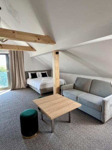 a living room with a couch and a table at Silence in Zator