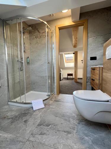 a bathroom with a shower and a white bath tub at Silence in Zator