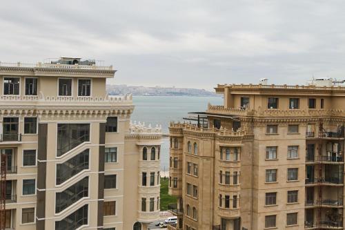 a view of two tall buildings and the water at Baku Sabah Apart in Baku