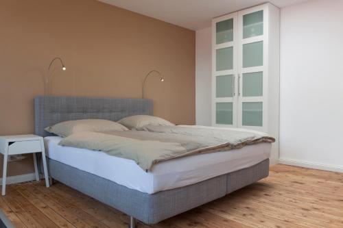 a bedroom with a large bed and a window at Dorotheenhof in Flensburg