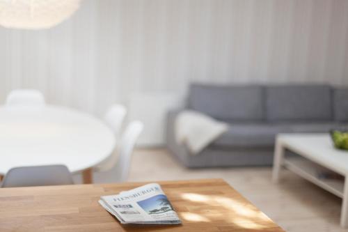 a living room with a table and a couch at Dorotheenhof in Flensburg