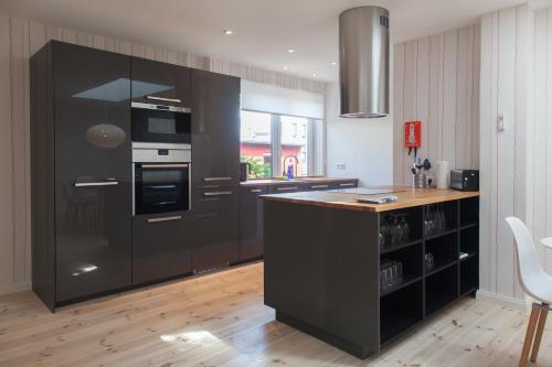 a kitchen with black cabinets and a counter top at Dorotheenhof in Flensburg